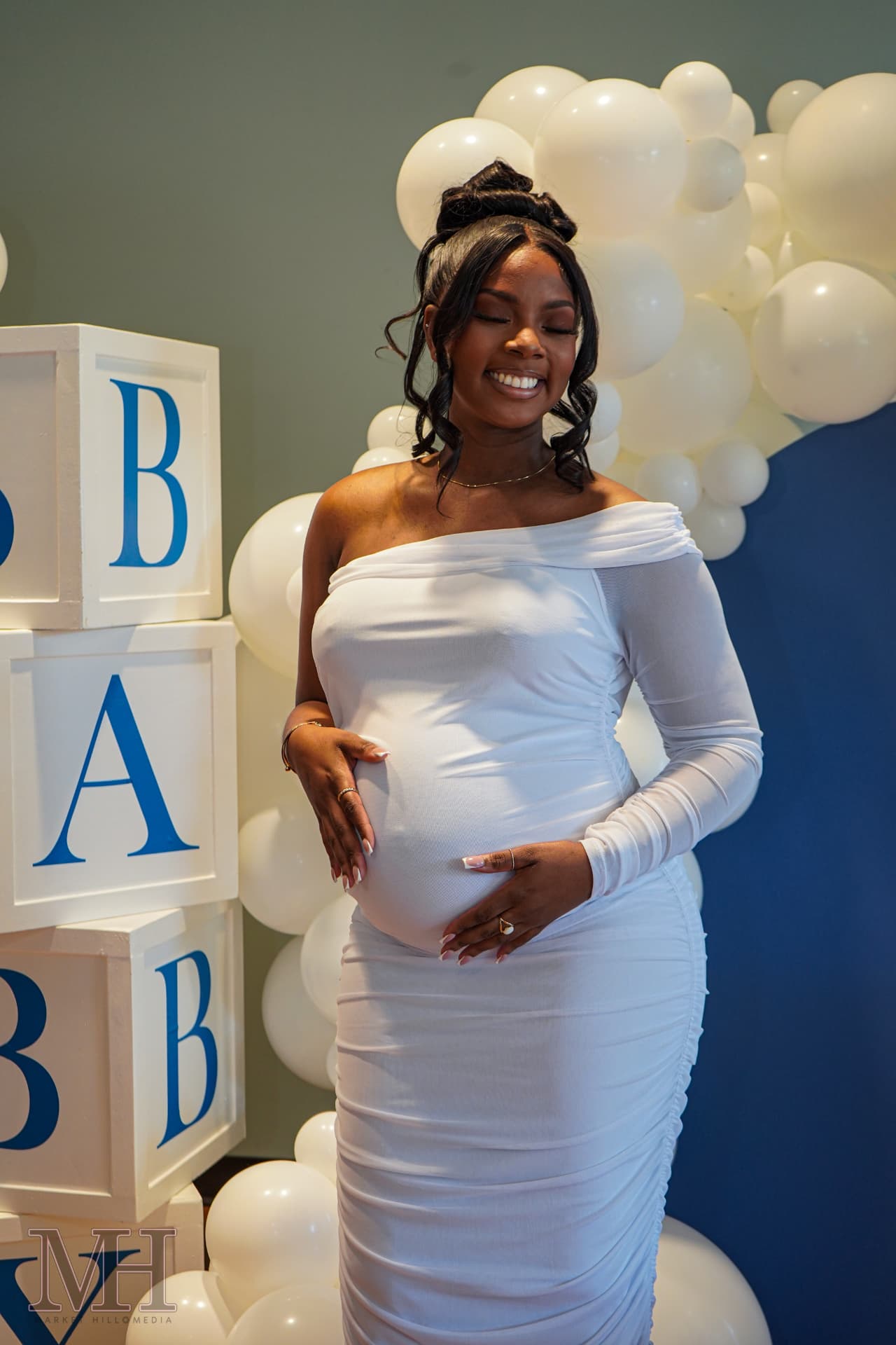 Expectant mother smiling at her baby shower